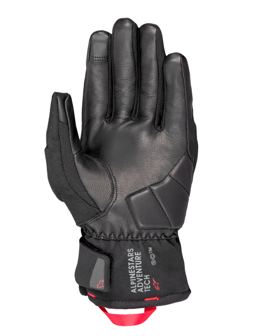 Alpinestars Crestone GORE-TEX Insulated Gloves, Motorcycle Gloves, Black, palm view featuring leather construction with reinforced impact padding, short cuff with Alpinestars Adventure Tech logo, and a bright red webbing pull loop