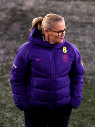 Sarina Wiegman Women’s International Friendly Match Puffer Jacket Puffer Jacket unisex front product view | Dash Racegear — Sarina Wiegman England Lionesses Women’s Purple Nike Hood Puffer Jacket with quilted insulation, perfect for chilly matchdays.