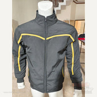 Apex softshell jacket front detail showing black fabric and yellow chest piping