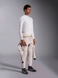 Alpinestars ZX Evo V3 Long Sleeve Top, White flame-resistant auto racing base layer, worn by a model with a racing suit tied around the waist, lightweight tech layer with mock neck and logo detail.