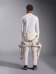 Alpinestars ZX Evo V3 Top - Long Sleeve, White auto racing base layer, back view of a person wearing the flame-resistant top with a racing suit pulled down to the waist, paired with black racing boots, professional motorsport underwear