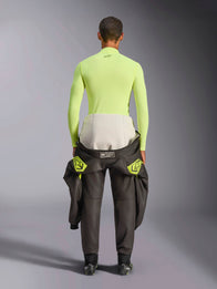 Alpinestars ZX Evo V3 Top, Long Sleeve Base Layer, Yellow Fluo, back view of a driver with a racing suit tied around the waist, vibrant neon yellow flame-resistant top featuring a small black logo on the neck and a slim athletic fit