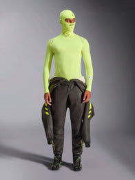 Alpinestars ZX Evo V3 Long Sleeve Top, Yellow Fluo, worn with matching balaclava and dark racing suit tied at waist, lightweight flame-resistant base layer for auto racing, featuring Alpinestars logos on the collar and shoulders