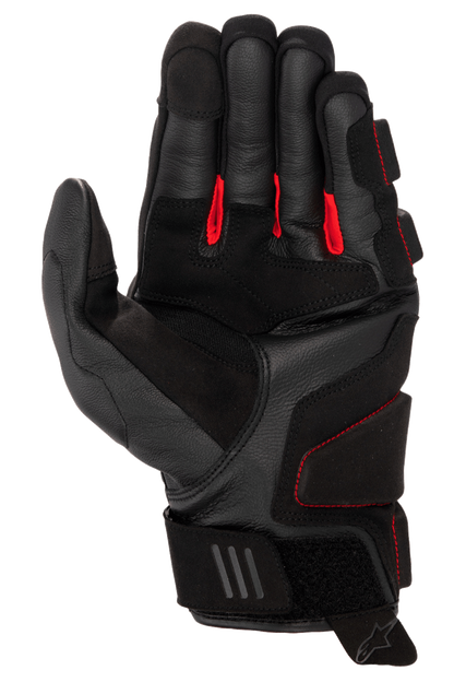 Alpinestars Phenom Leather Gloves, Motorcycle Gloves, Black and Bright Red, palm side view showing premium goat leather, red fabric between fingers, reinforced impact zones, and adjustable velcro wrist closure