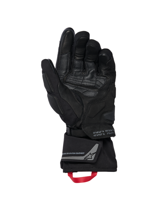 Alpinestars WT-8 GORE-TEX Insulated Gloves, Motorcycle Gloves, Black, inner palm view showing reinforced leather patches and padded sliders, long cuff with a red pull loop and Alpinestars Exploration Equipment branding with geographic coordinates, technical road and adventure design
