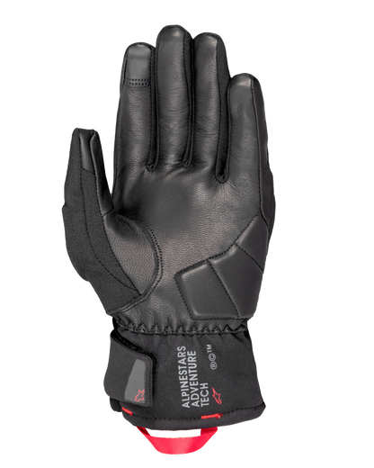 Alpinestars Crestone GORE-TEX Insulated Gloves, Motorcycle Gloves, Black, palm view featuring leather construction with reinforced impact padding, short cuff with Alpinestars Adventure Tech logo, and a bright red webbing pull loop