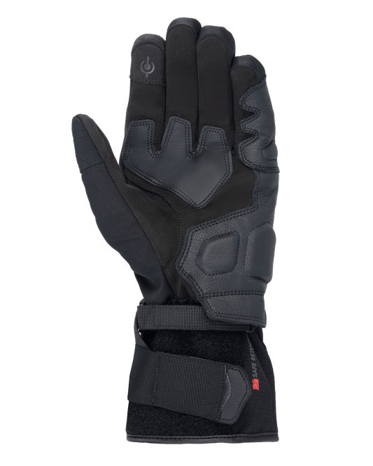 Alpinestars Tourer W-7 V2 Drystar® Gloves, Black motorcycle gloves, palm view featuring leather reinforcements, padded grip areas, touchscreen-compatible fingertip, and secure wrist strap closure.