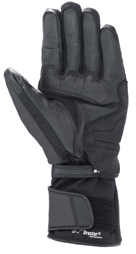 Alpinestars Denali Aerogel Drystar® Gloves, Black, palm view featuring reinforced material panels, textured grip on fingers, and adjustable long cuff with Drystar® Performance branding, winter motorcycle gear for adventure touring
