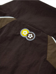 VTP x Asics Track Jacket Jacket unisex detail view 4 | Dash Racegear — Asics x Vandy The Pink 2026 jacket showcasing a rich brown finish with premium comfort and modern athletic style.