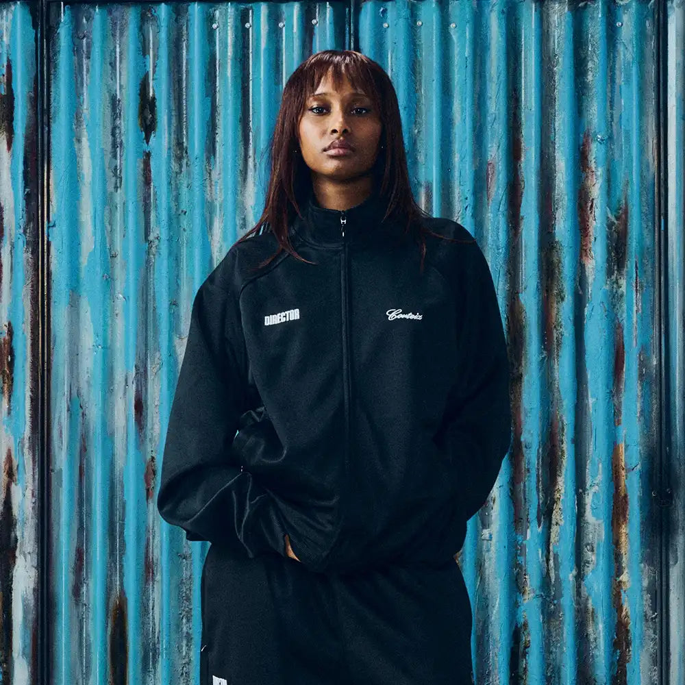 Corteiz x Gabriel Moses Track Jacket Jacket unisex front product view | Dash Racegear — Black 2026 Regina track jacket from Corteiz x Gabriel Moses, unisex street zip layer for everyday casual wear.