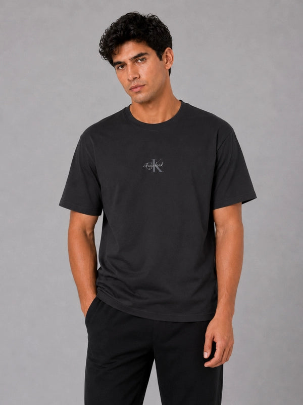 Jungkook x Calvin Klein Monogram T-shirt Shirt unisex detail view 5 | Dash Racegear — Jungkook Calvin Klein tee in Black displaying repeating logo artwork with everyday crew collar and smooth jersey cloth
