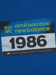 ALD x New Balance Running Bib T-Shirt Shirt unisex detail view 4 | Dash Racegear — New Balance x Aimé Leon Dore 2026 Blue Running Bib Unisex T-Shirt with a relaxed fit and modern athletic style.