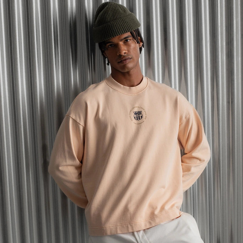 Barça Essentials Graphic Crew Sweatshirt Sweatshirt unisex front product view | Dash Racegear — Front shot of Barça Essentials 2025 graphic peach fleece sweatshirt.