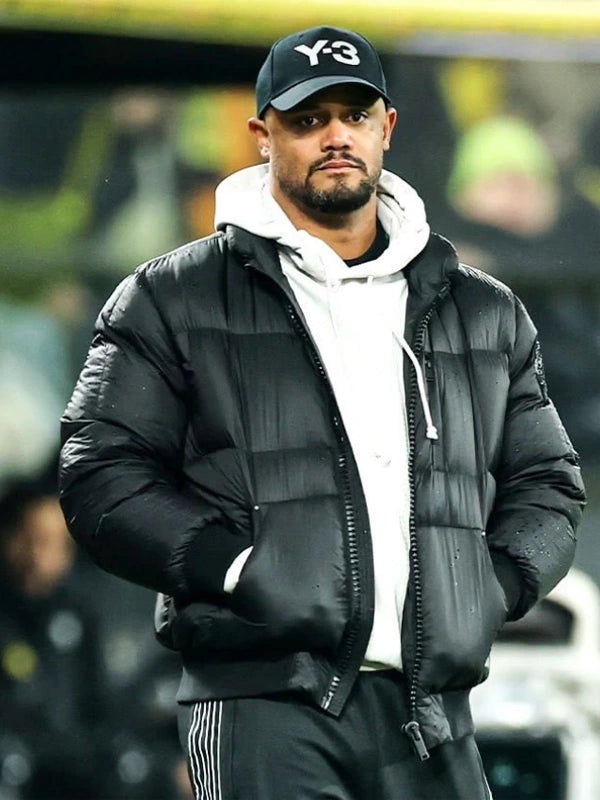 UEFA Champions League Vincent Kompany Puffer Jacket Puffer Jacket unisex front product view | Dash Racegear — UEFA Champions League Signal Iduna Park 2026 black puffer jacket, Vincent Kompany sideline style for cold match days.