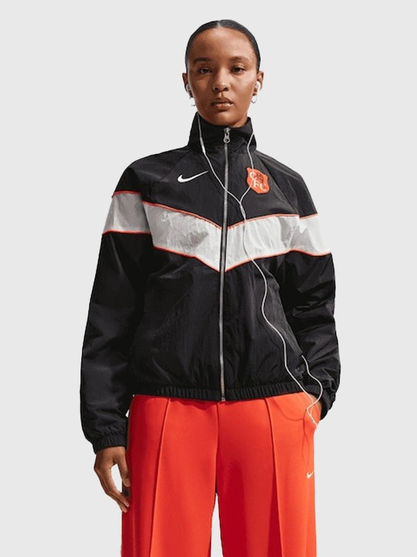 Chelsea Nike Woven Windrunner Jacket Jacket unisex front product view | Dash Racegear — Chelsea F.C. Nike Windrunner Woven Full-Zip Jacket, black, women’s fit with stylish team-inspired details.