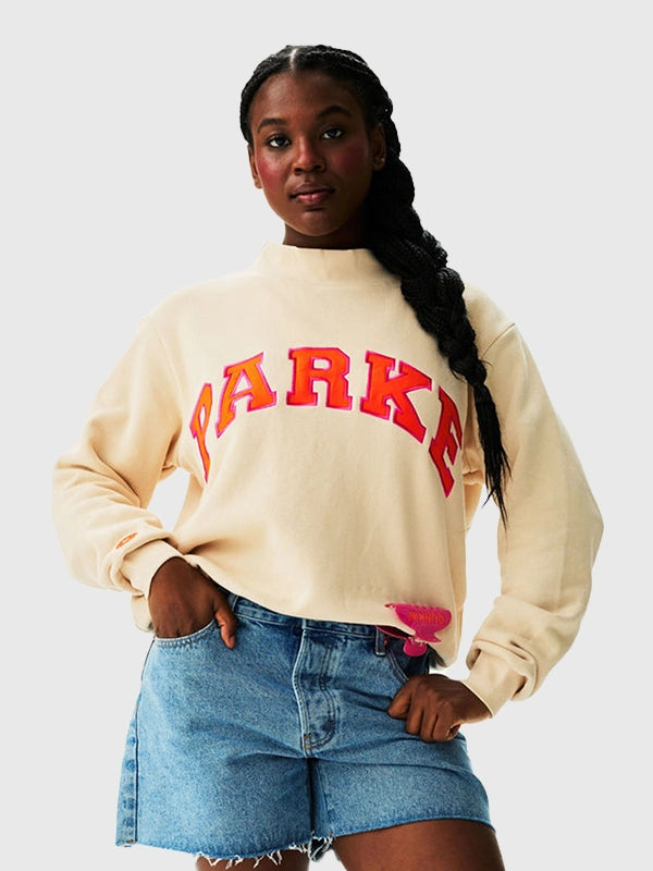 Parke x Dunkin’ Varsity Mockneck Cream Sweatshirt Sweatshirt unisex front product view | Dash Racegear — Parke x Dunkin' 2026 Varsity Mockneck Women's Fleece Sweatshirt in Cream with cozy warmth and premium everyday comfort.