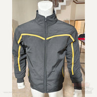 Apex softshell jacket front detail showing black fabric and yellow chest piping