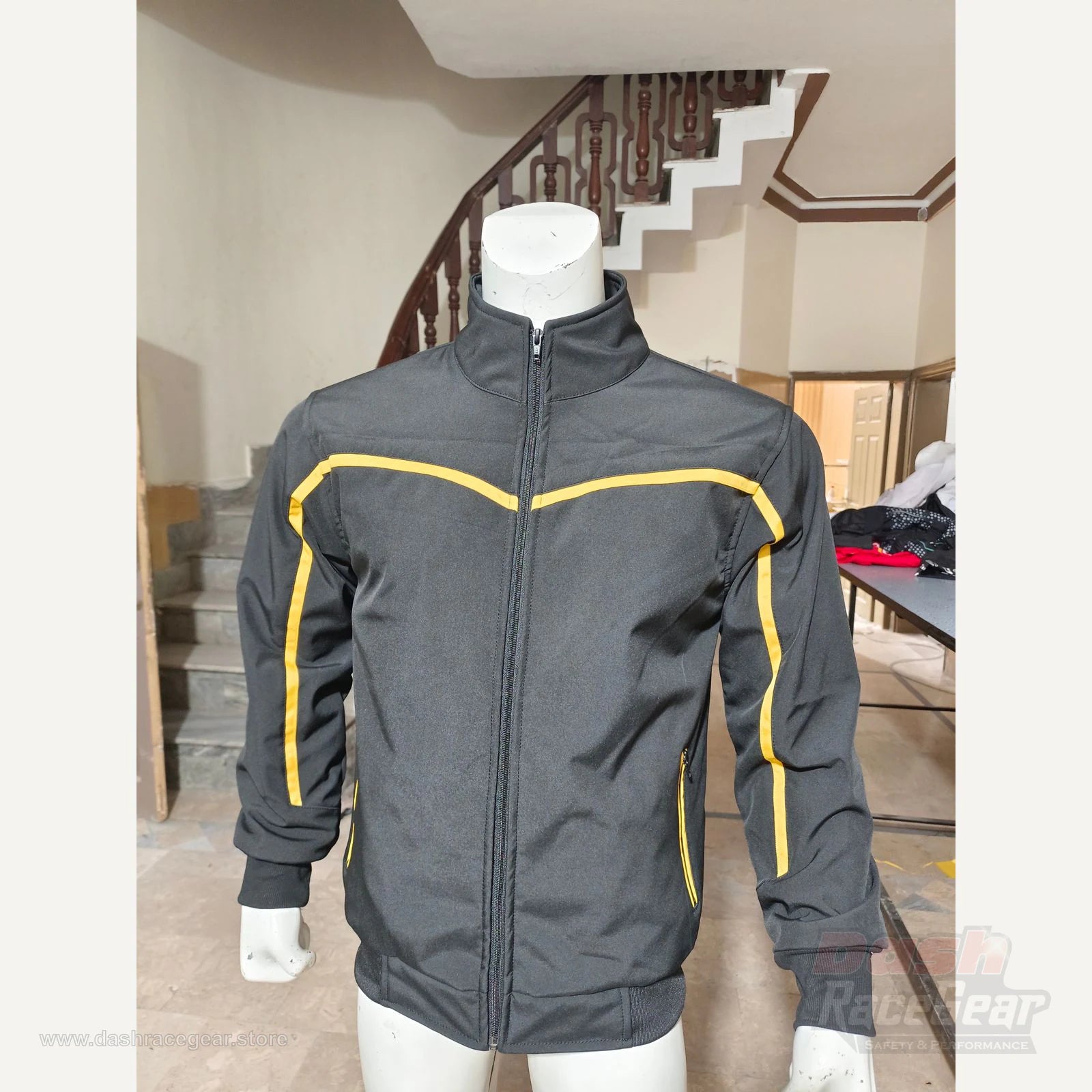Apex black and yellow softshell jacket full front with stand collar and zip closure