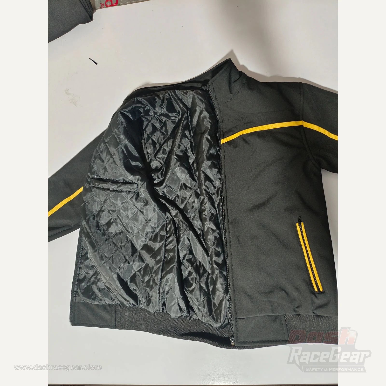 Apex softshell jacket opened to display padded quilted inner lining and pocket
