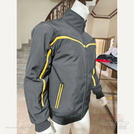 Apex black and yellow quilted softshell jacket side angle and zip pocket detail