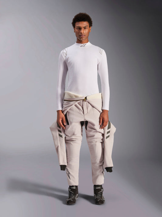 Alpinestars ZX Evo V3 Top, Long Sleeve, White, auto racing base layer worn with a light-colored racing suit tied around the waist and black racing boots, featuring a mock neck with logo and shoulder branding, professional flame-resistant motorsport underwear