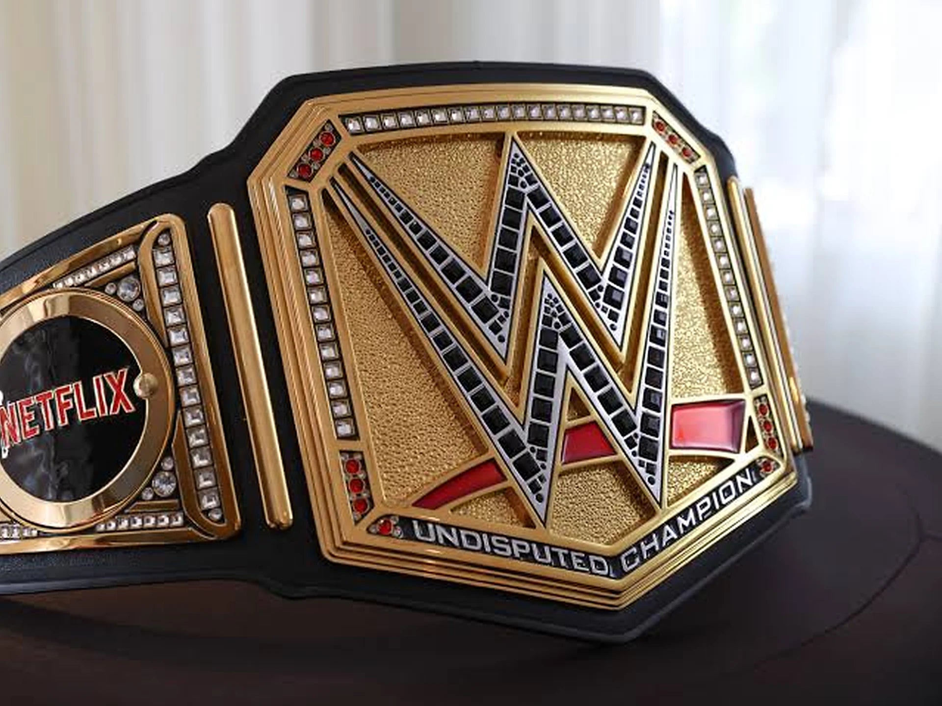 Gold and black wrestling championship-style title belt featured in the Dash Racegear championship belts collection