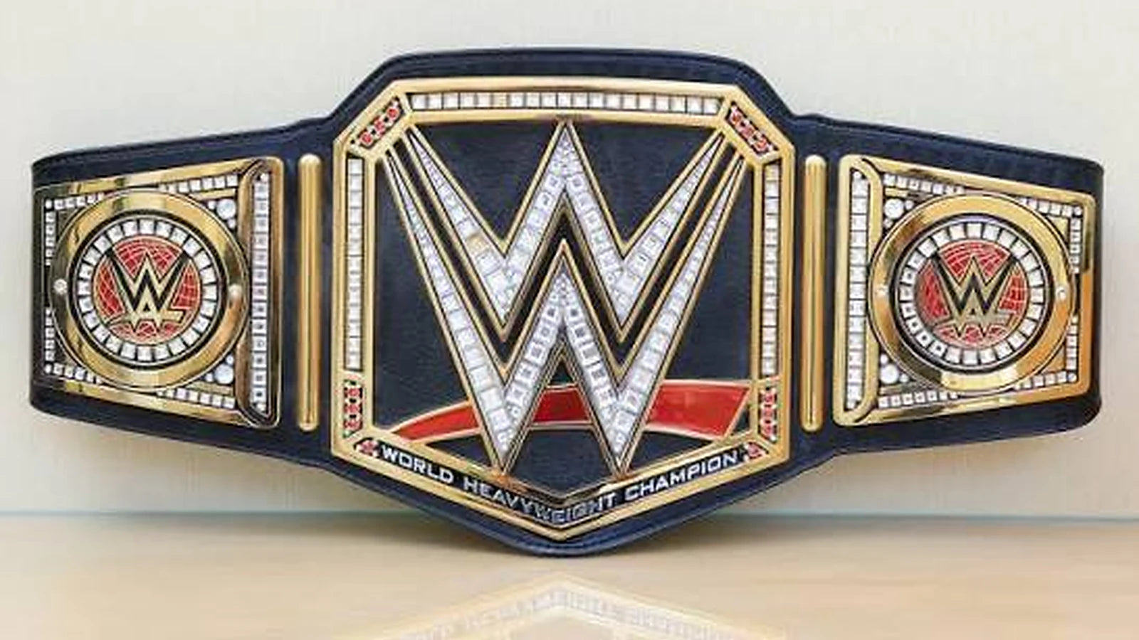 Black and gold world heavyweight championship-style belt banner for the Dash Racegear WWE Mini Belts collection